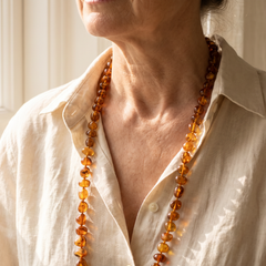 Amber bead necklace worn with a linen shirt